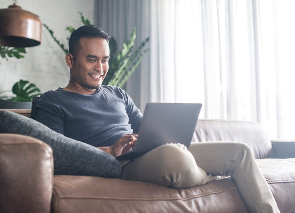 smiling man with laptop