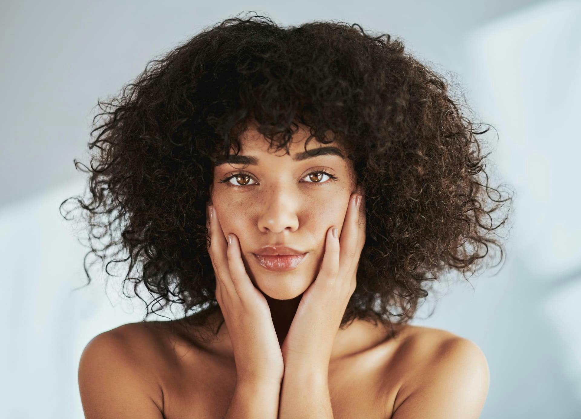 woman holding cheeks