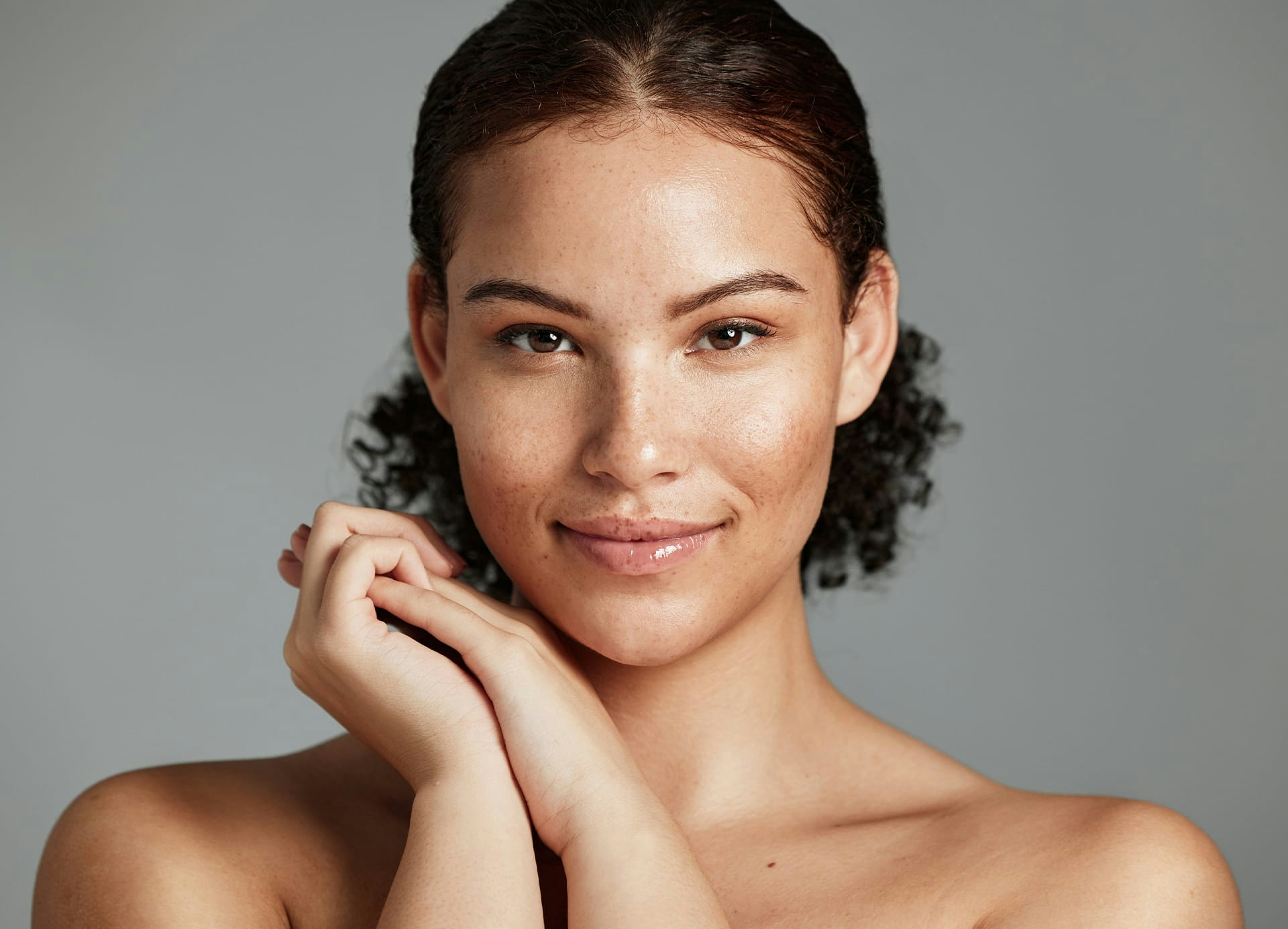 Woman smiling with hands together