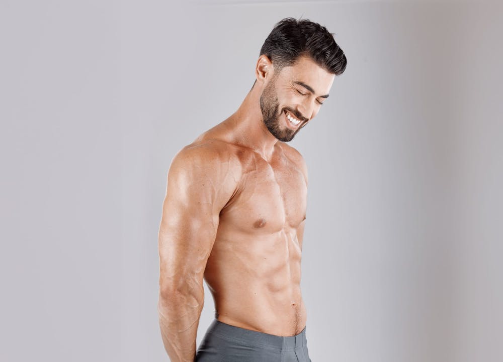 shirtless man smiling