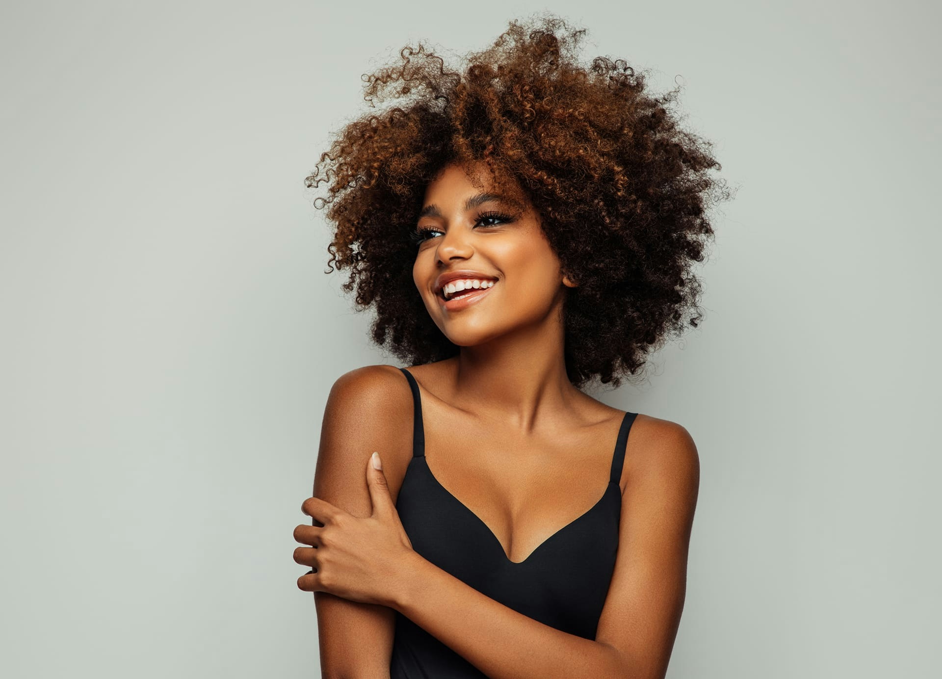 smiling woman with afro