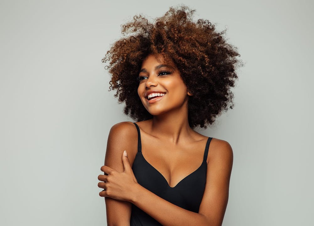 smiling woman with afro
