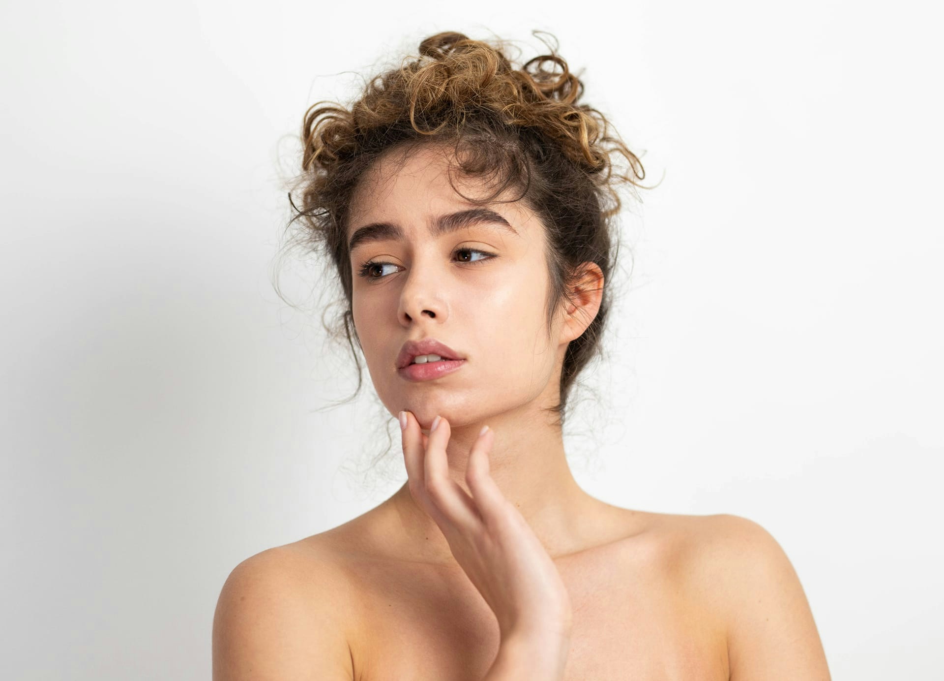 woman holding chin