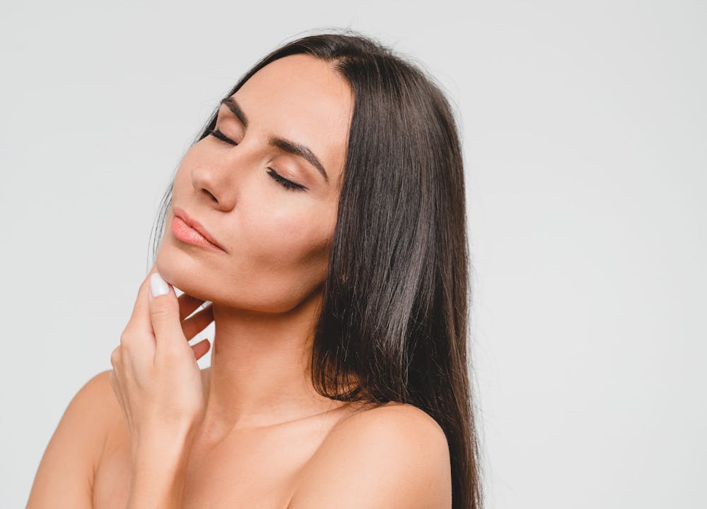 smiling woman touching chin