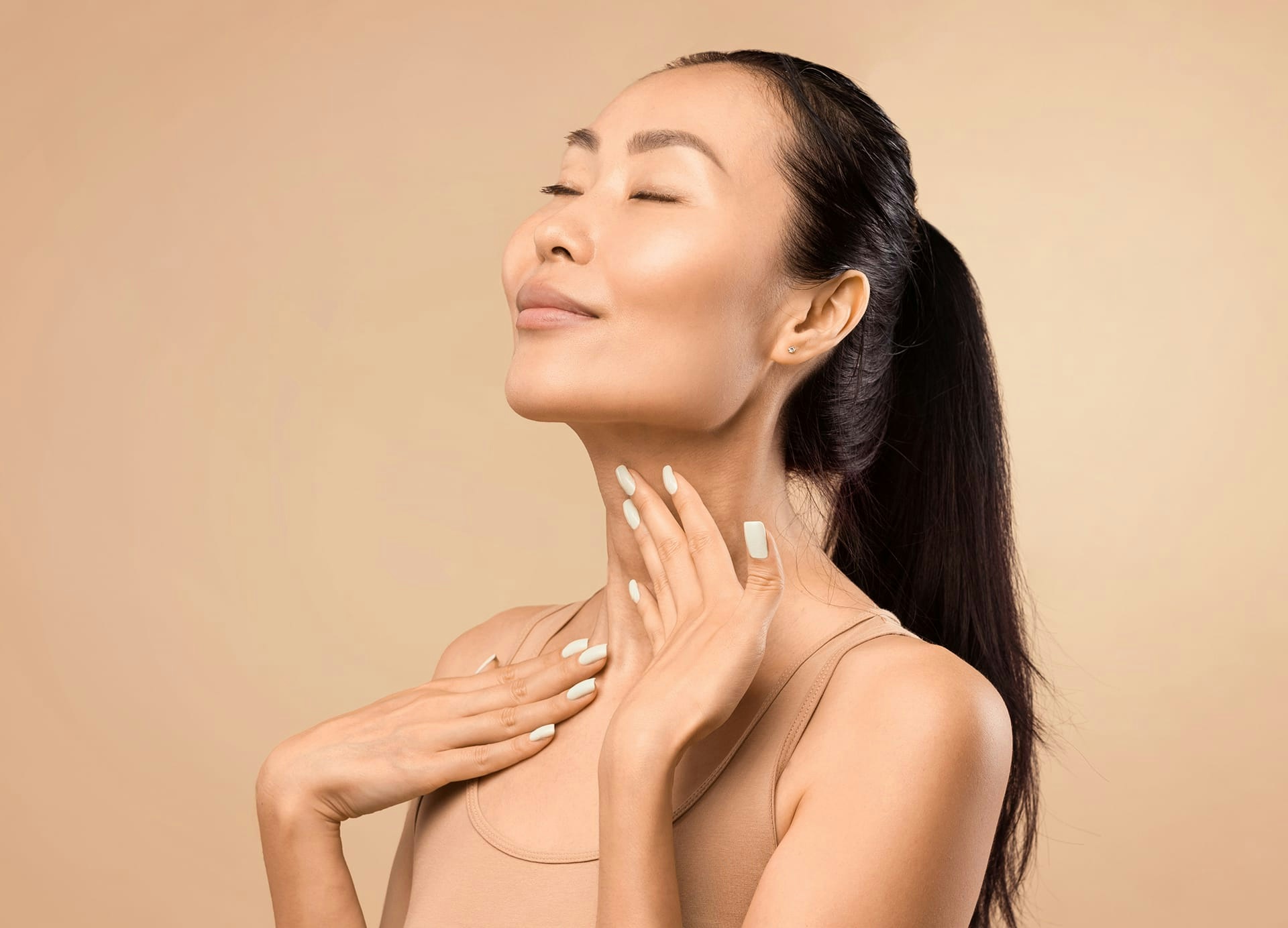 smiling woman caressing neck