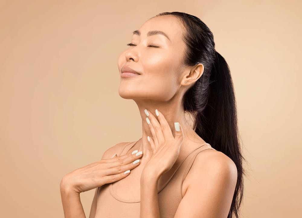 smiling woman caressing neck