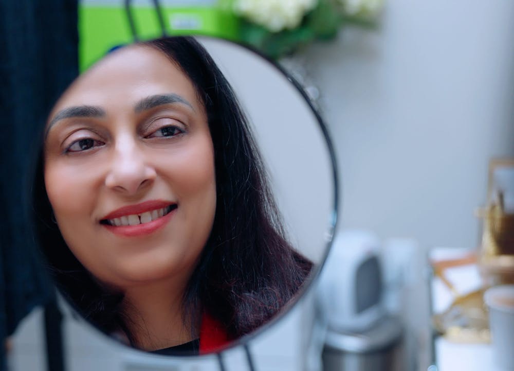 woman looking in mirror