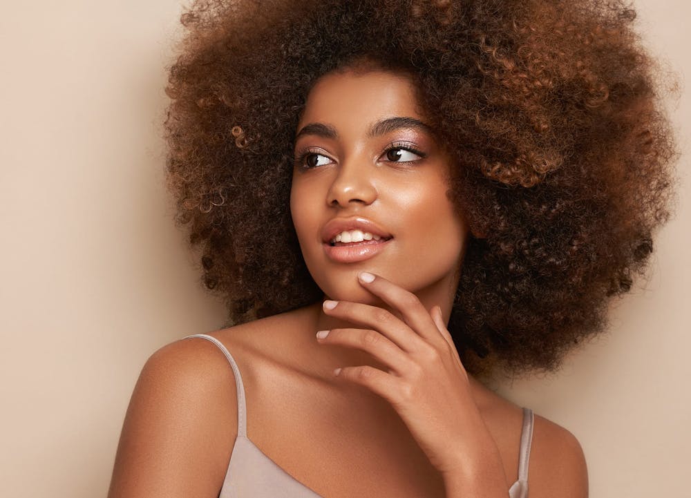 smiling woman with afro