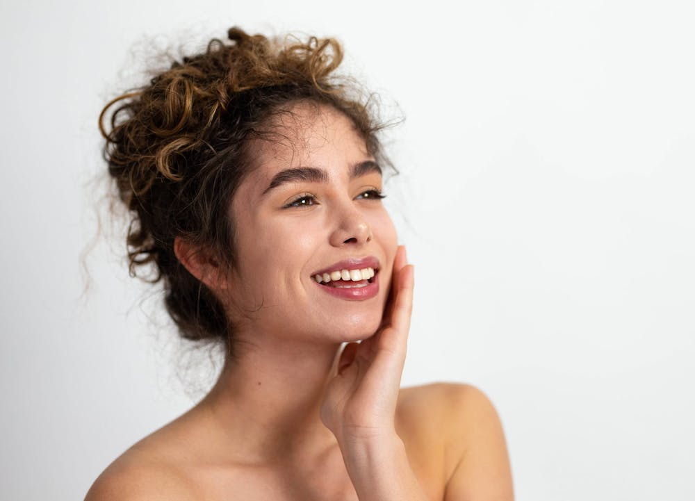 smiling woman touching cheek