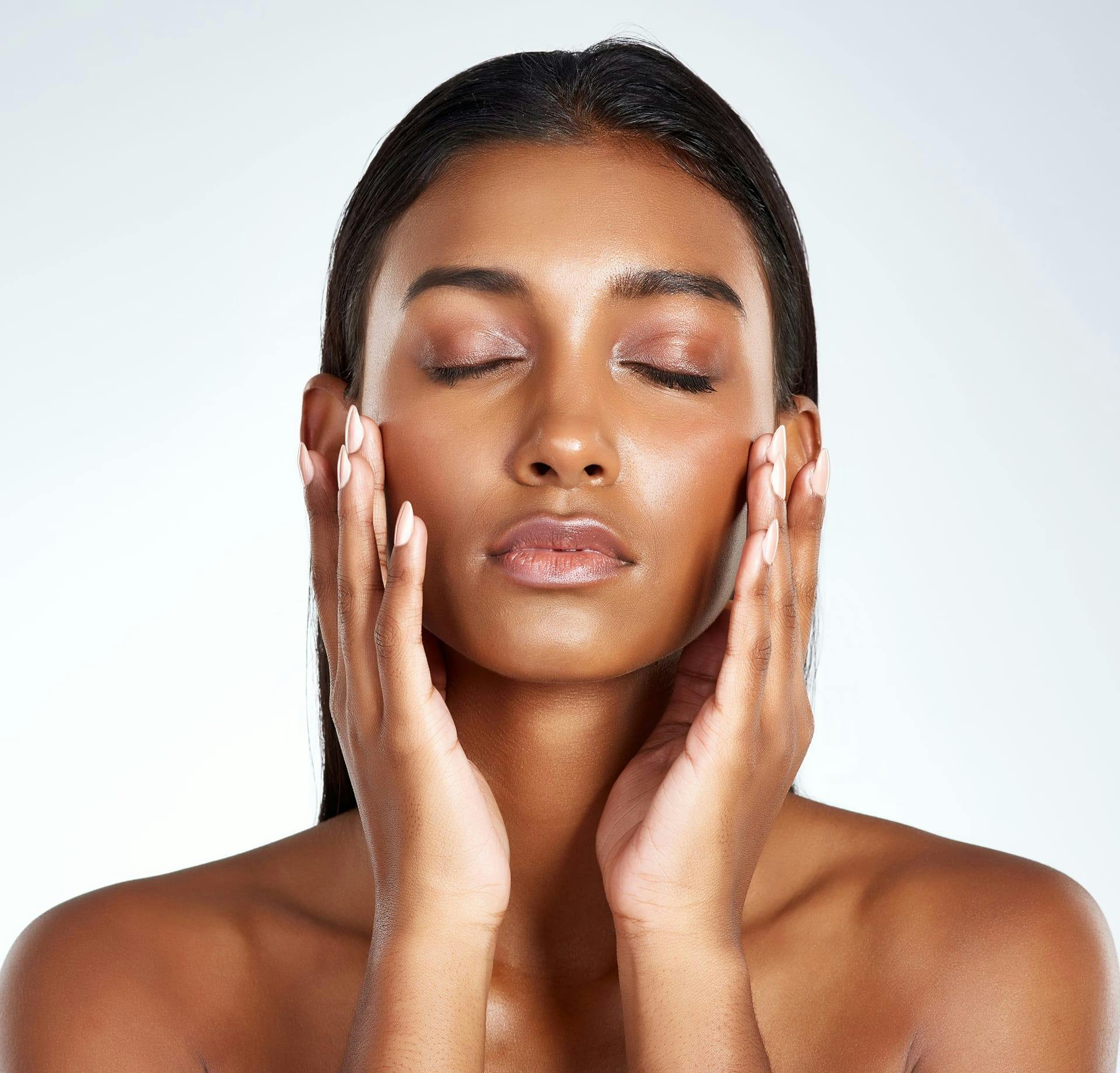 woman holding cheeks