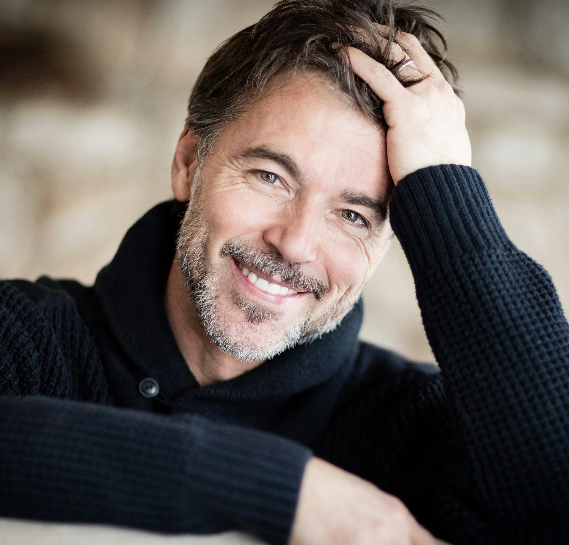 smiling man wearing sweater