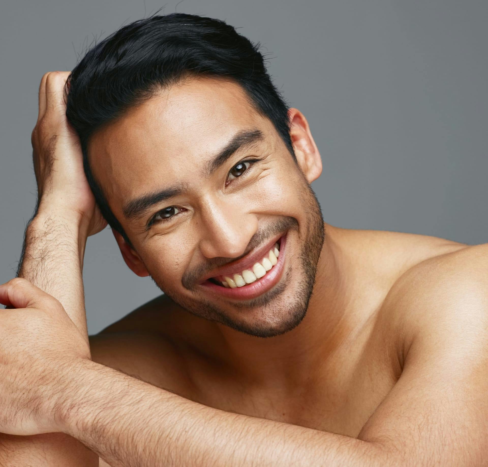 smiling man holding head