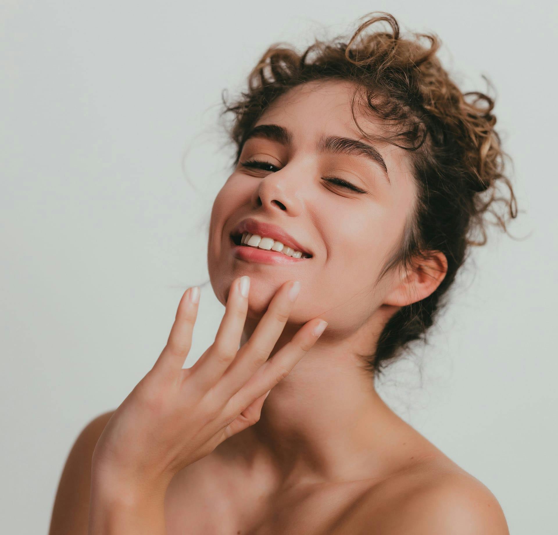 smiling woman touching chin