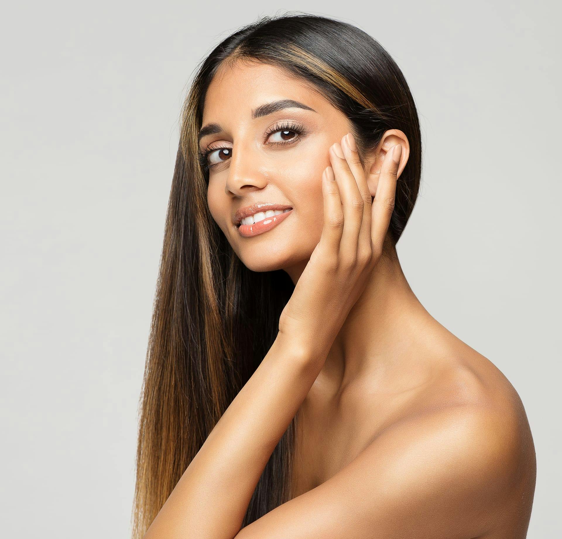 smiling woman touching cheek