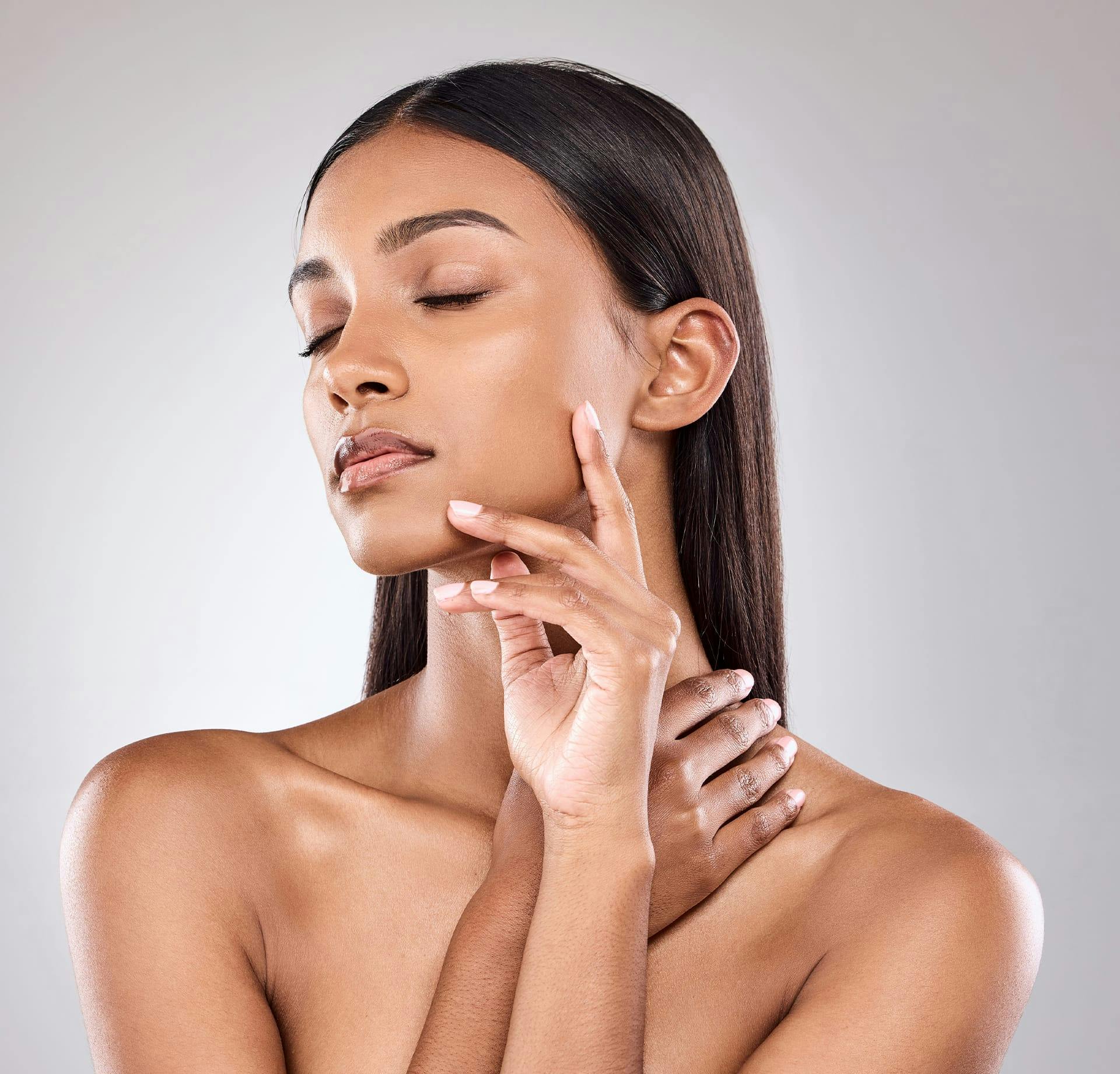 woman touching her cheek