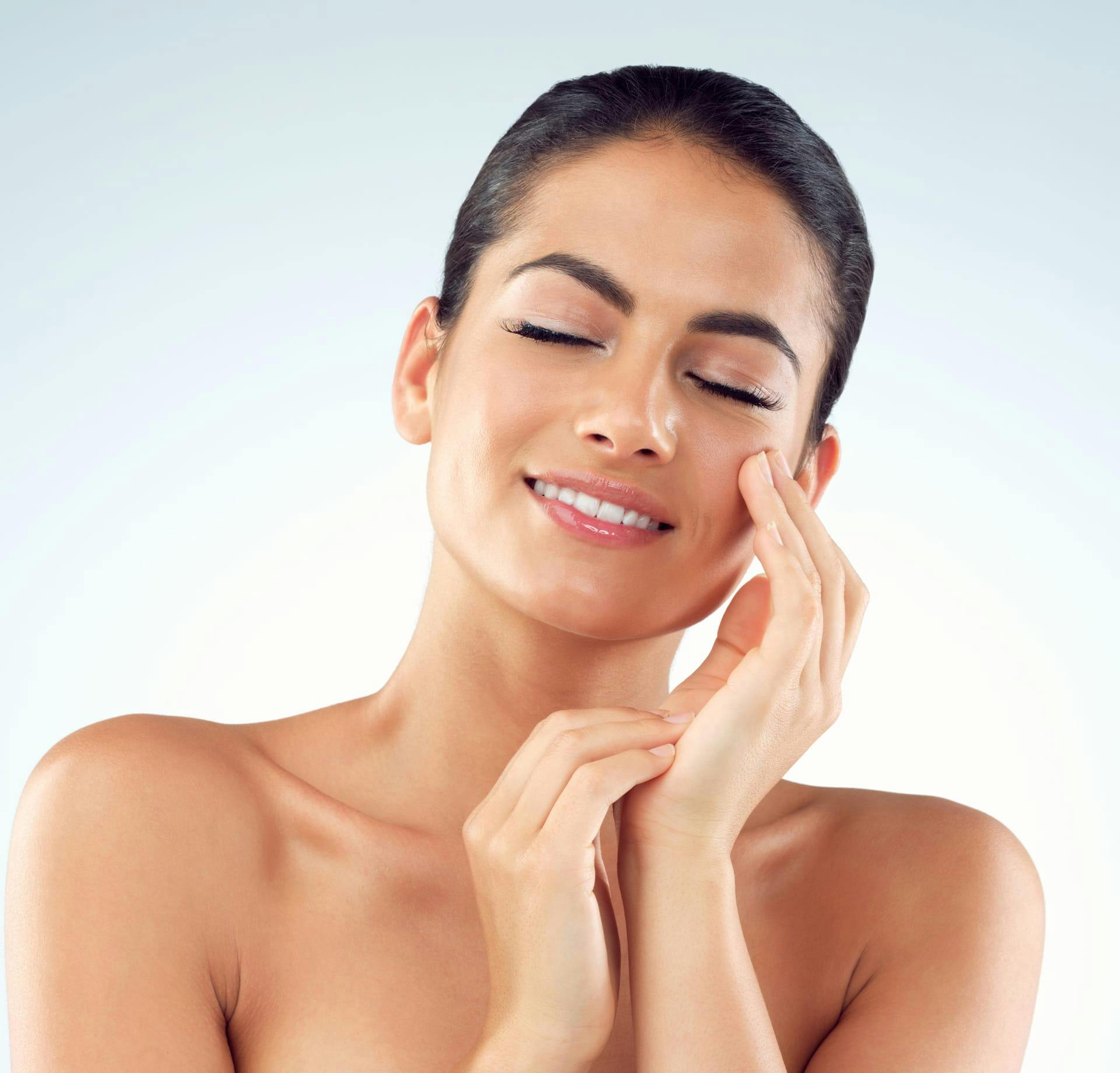 smiling woman holding her cheek