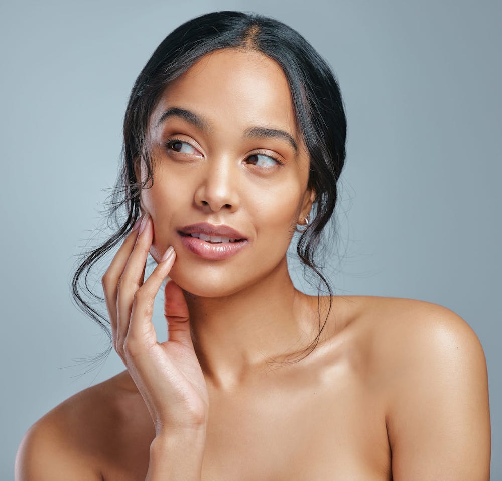 woman glancing ot the side holding cheek