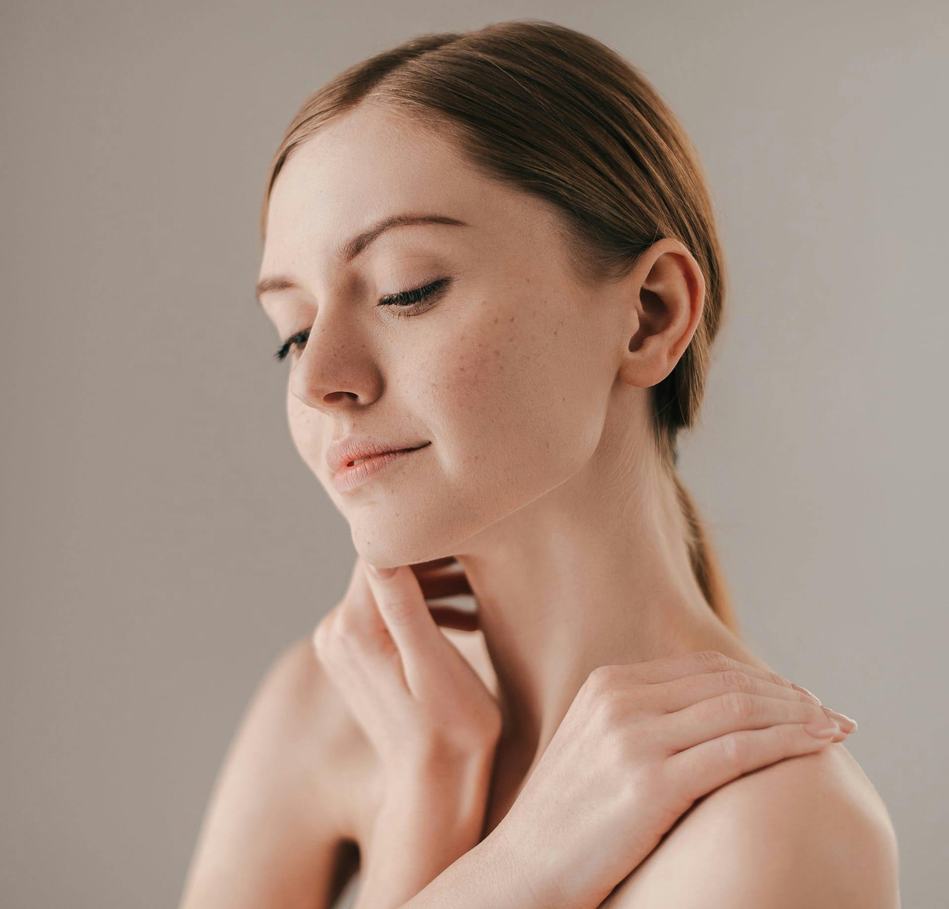 Woman brushing hand over her chin