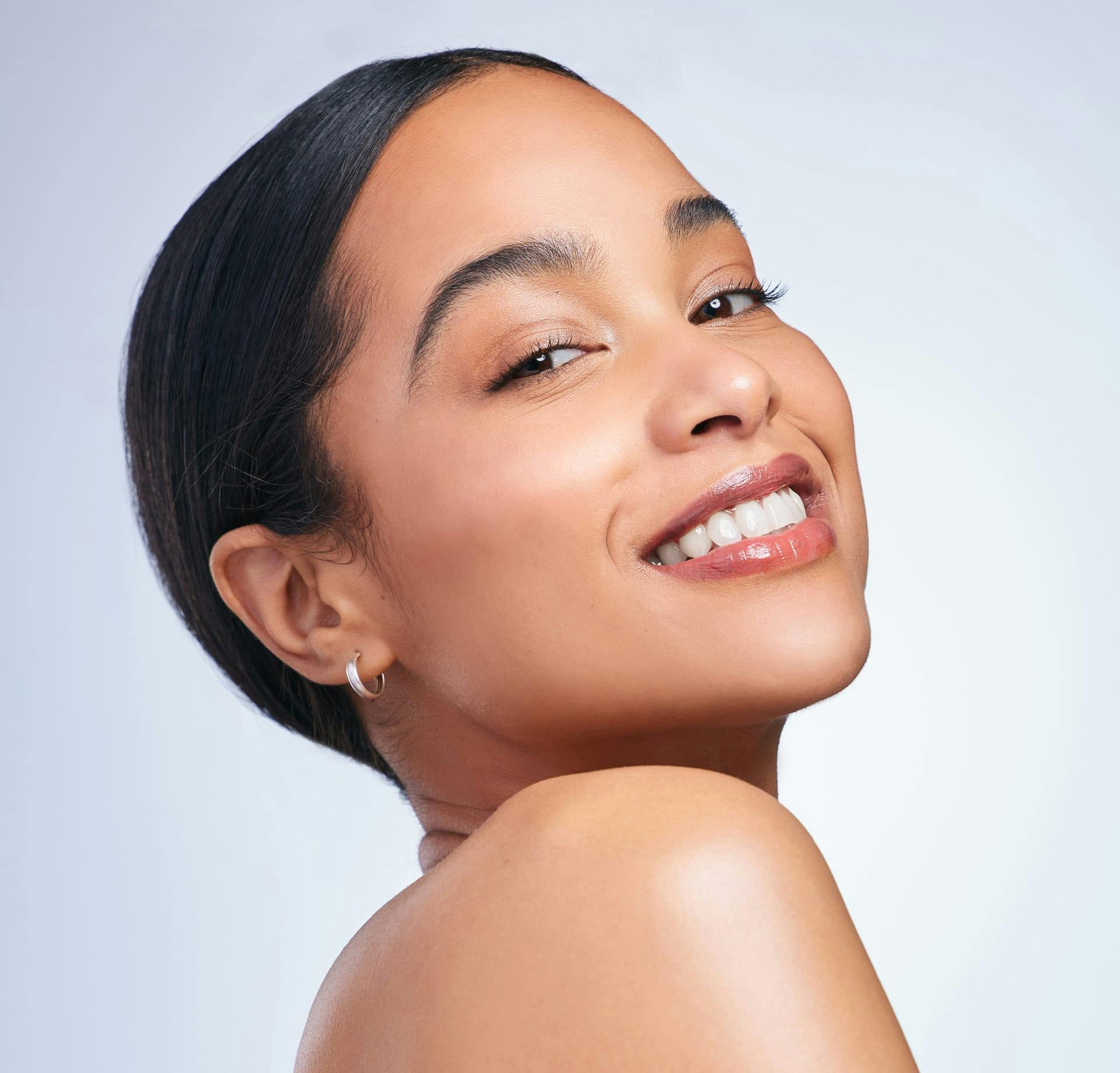 Woman smiling over shoulder