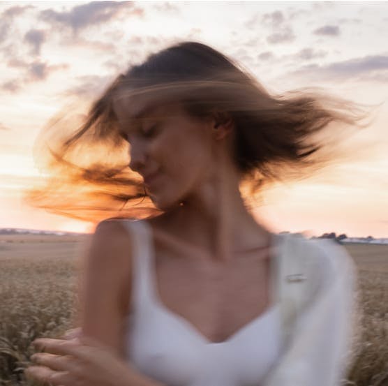 Woman shaking her head at dusk