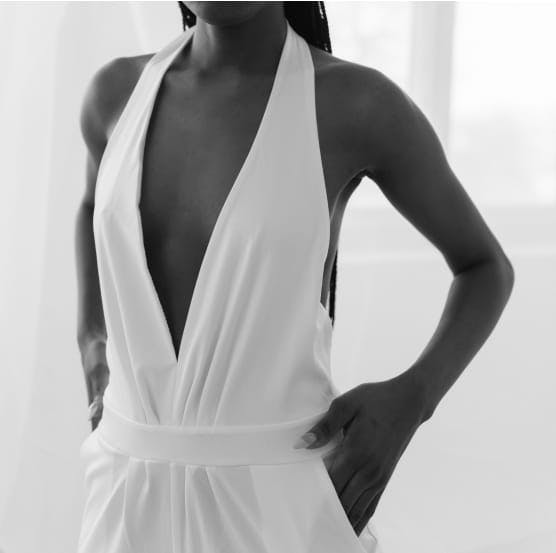 Torso of a black woman in a white dress
