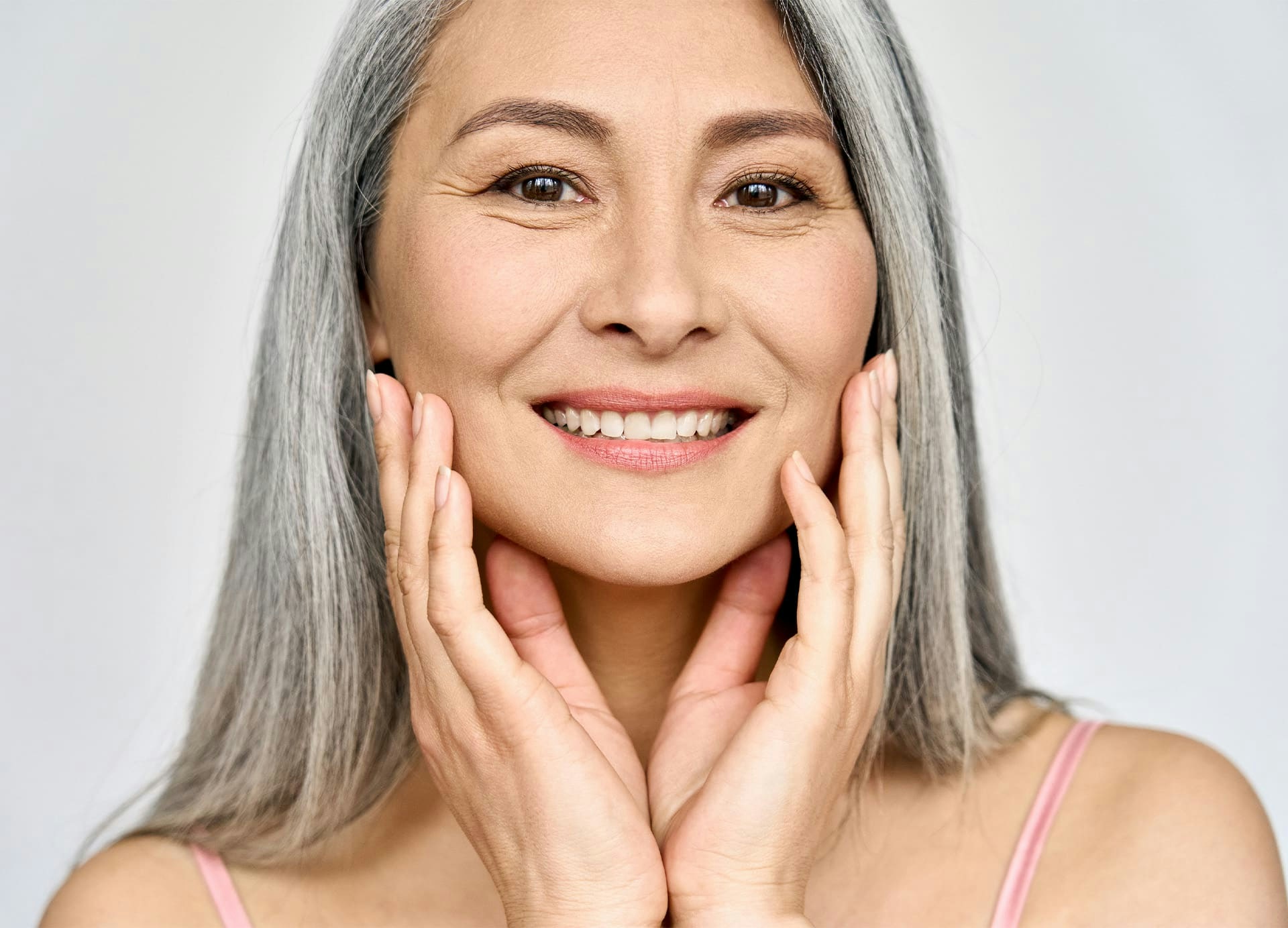 older woman with long grey hair smiling