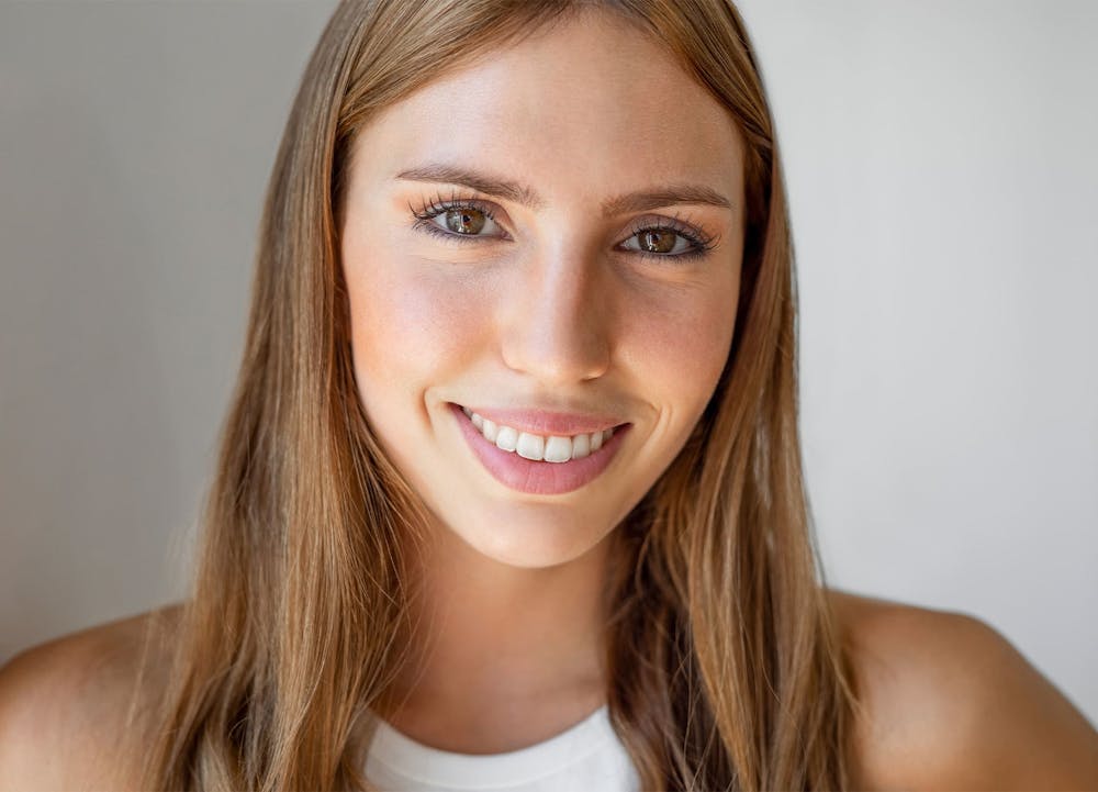 woman with dark blonde hair smiling