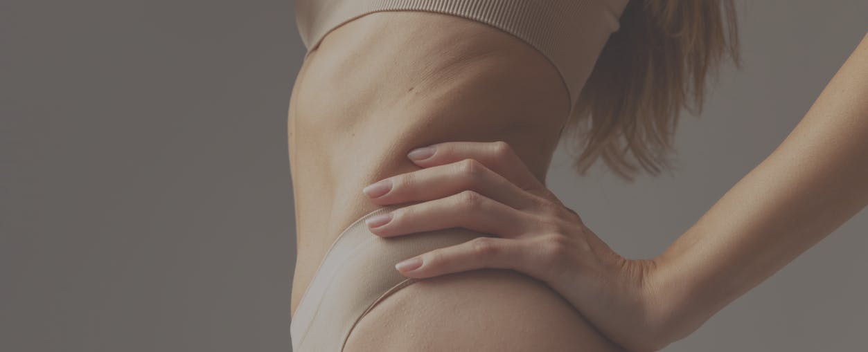 Photo of womans body that is fit in studio shoot. Her firm and smooth skin show the potential results of IgniteRF in Boston with Neem