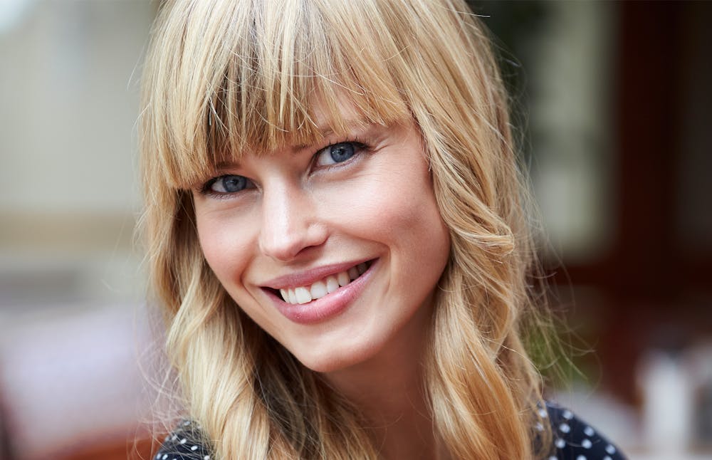 blond woman smiling at the camera