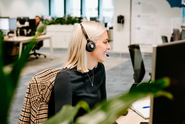 Woman with a headset on a sales call