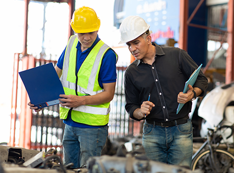Health and safety consultant and site manager in hard hats