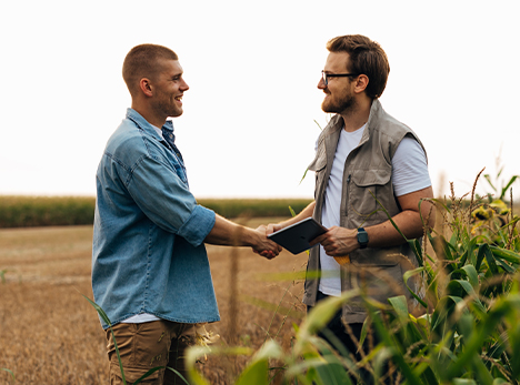 Farmer shakes hands with health and safety consultant