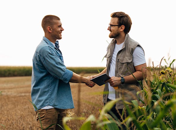 Farmer shakes hands with health and safety consultant
