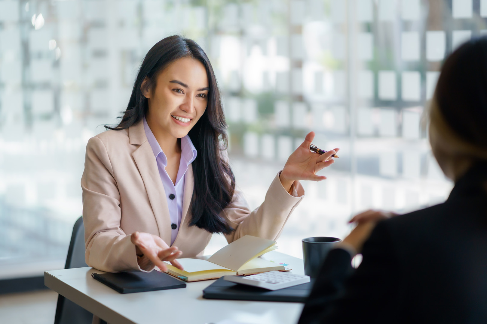 Woman in blazer describes HR services to client