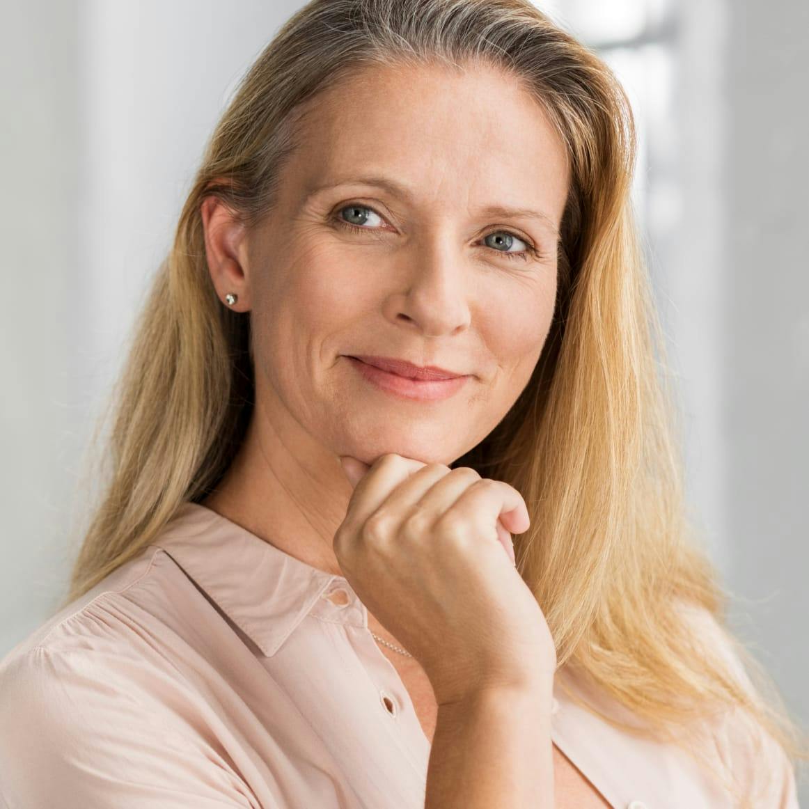 Woman with a hand to her chin