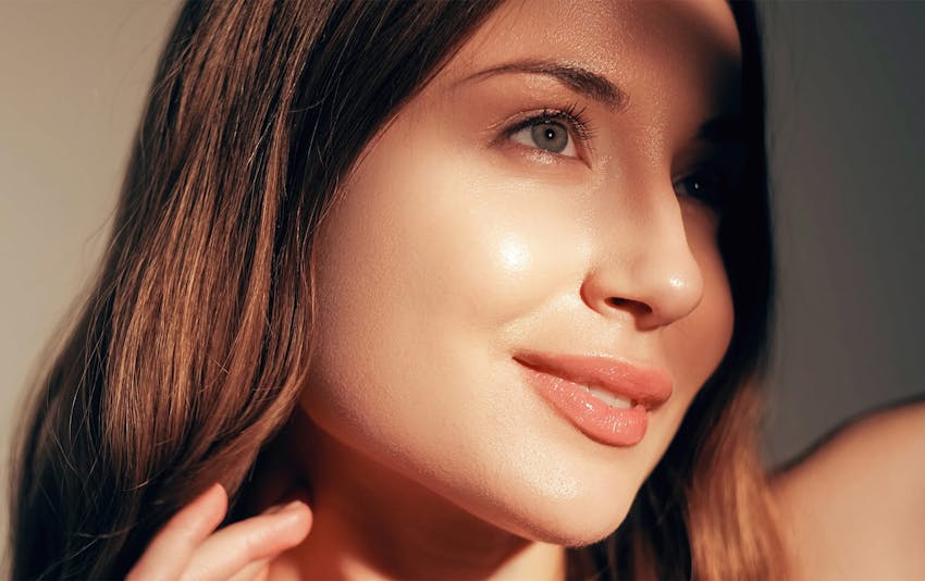 close up of woman's face with the sun on her face