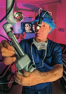 Dr. Miller wearing scrubs working with a machine