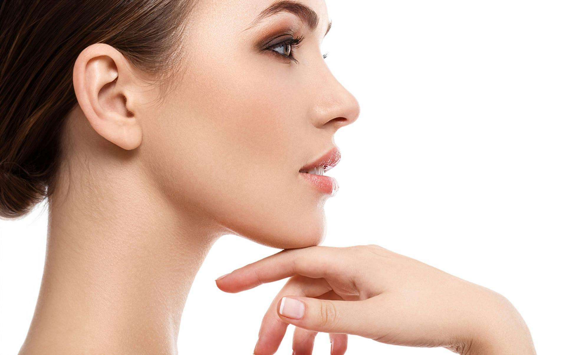 side angle of a woman with her hand touching her chin