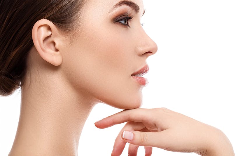 side angle of a woman with her hand touching her chin