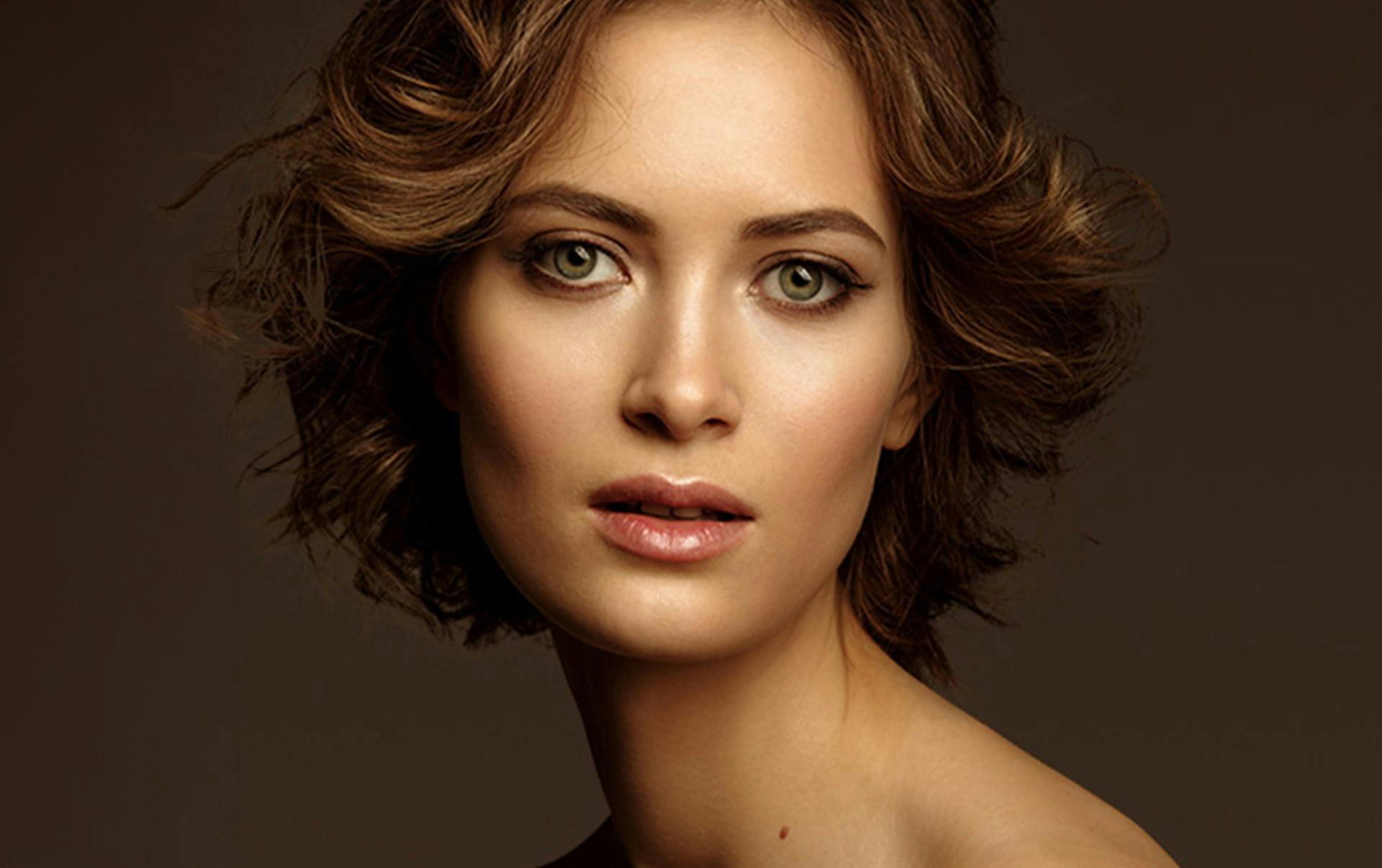 woman with short brown hair looking forward