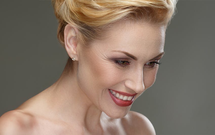 woman with blonde hair looking downwards