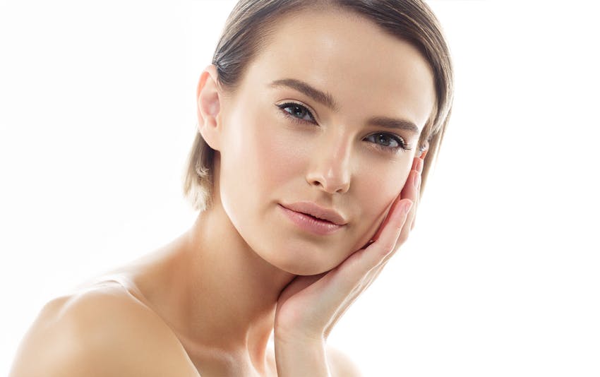 woman resting her head in her hands with short hair