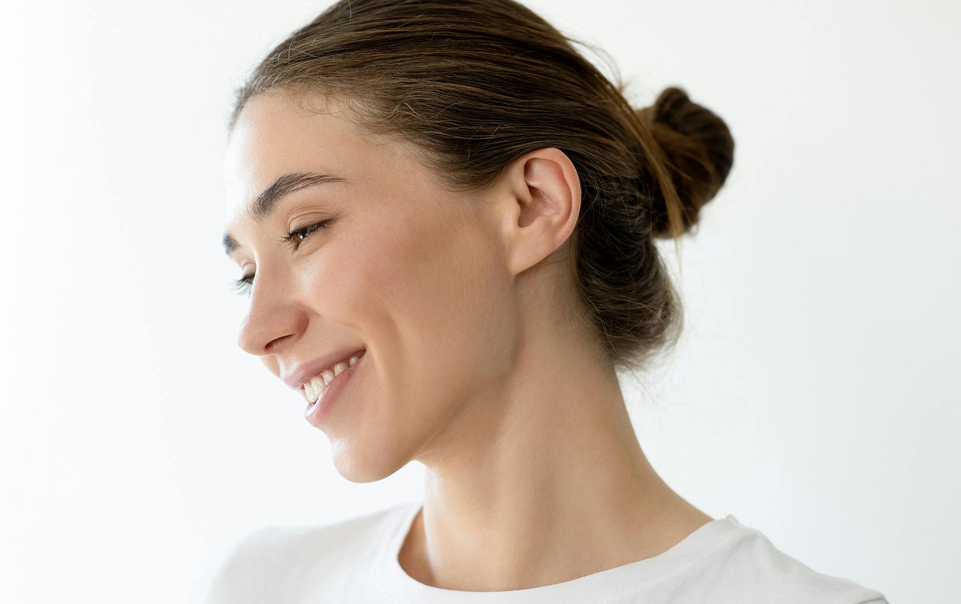 woman with her arms crossed in white shirt