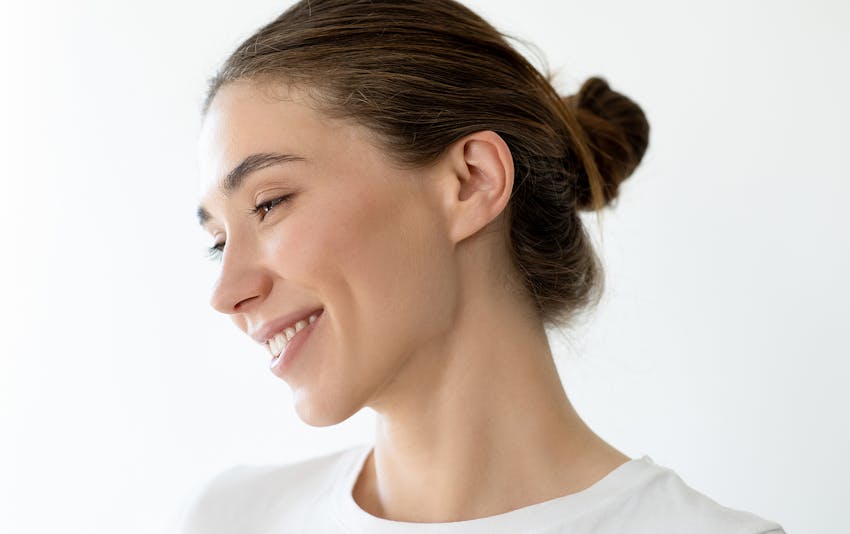 woman with her arms crossed in white shirt