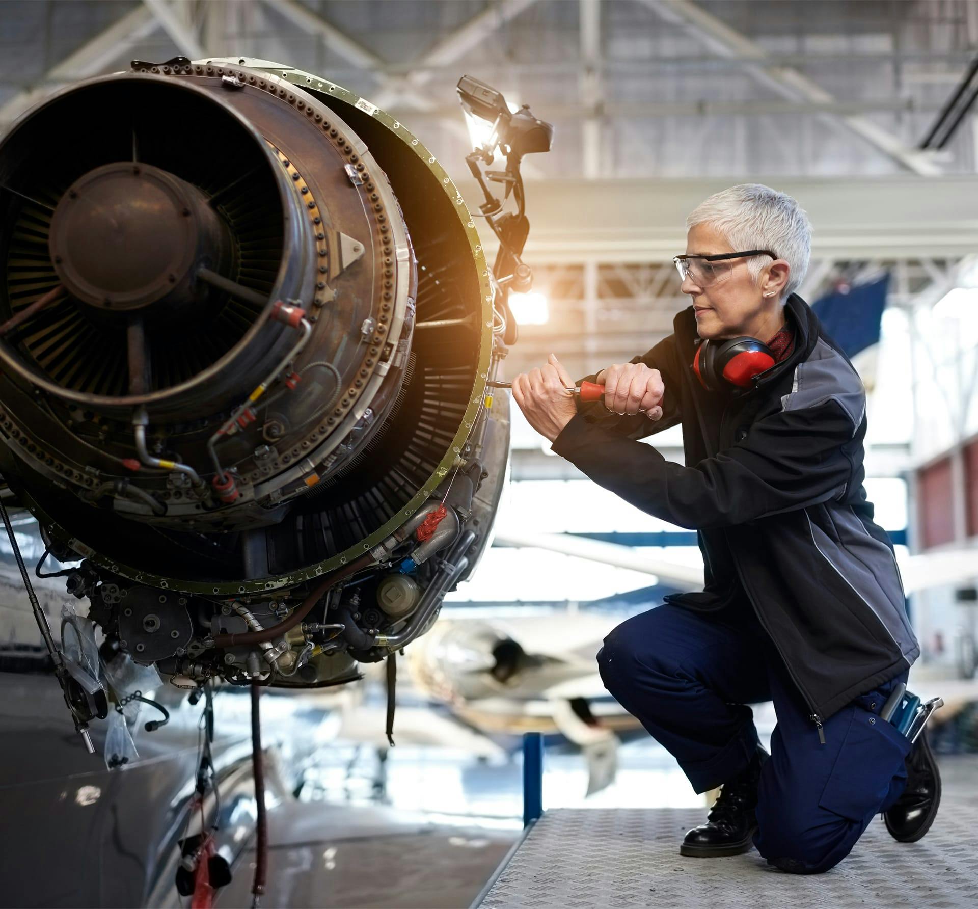 woman working aircraft piece
