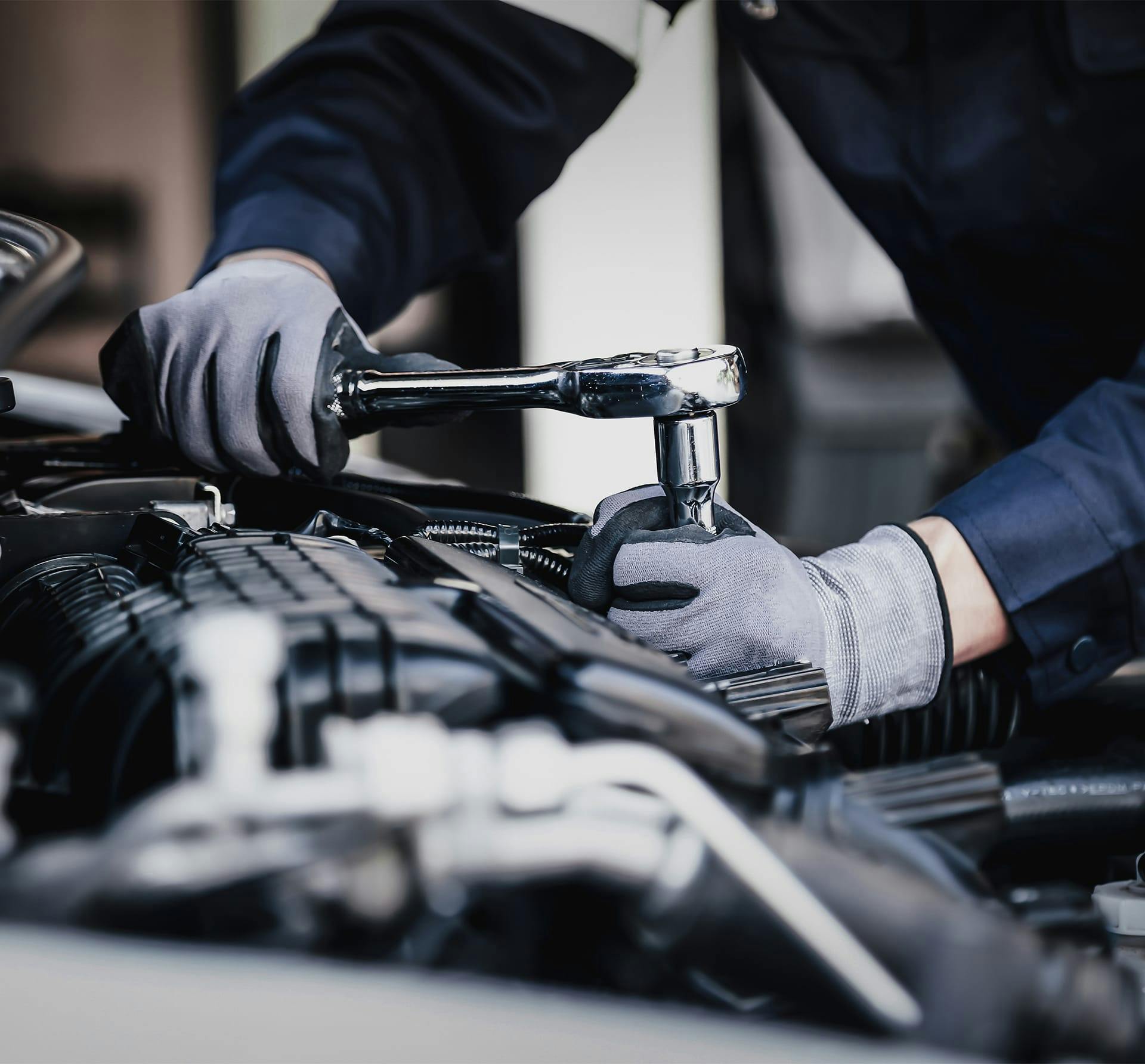 close up of someone working on car engine
