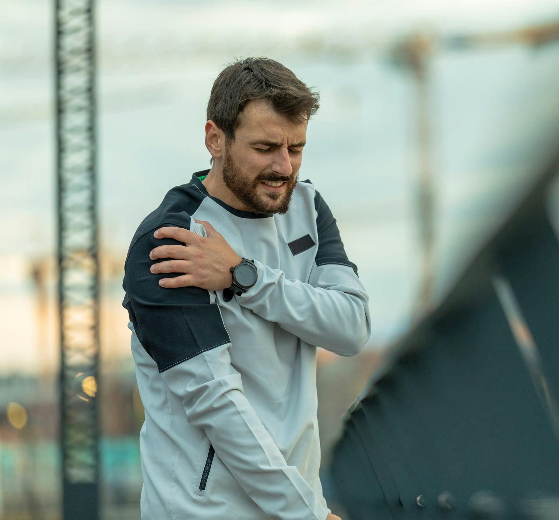 man holding shoulder while outside