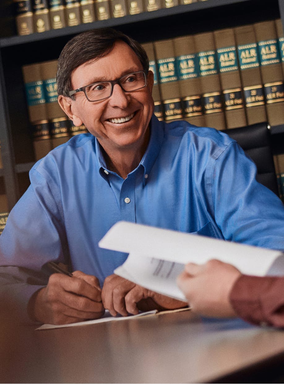 man in blue shirt smiling while sitting