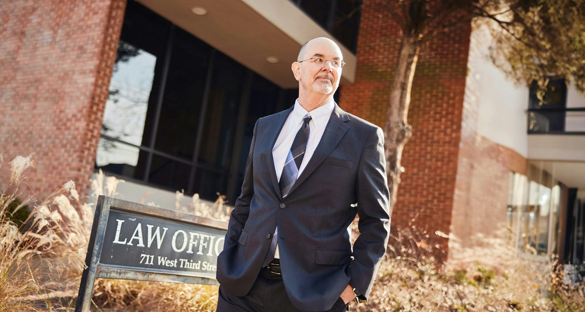 man in front of law office sign