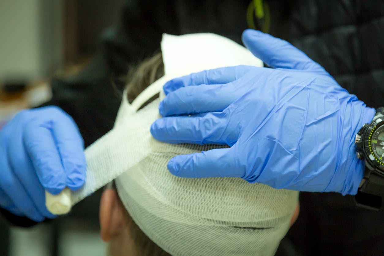 A person's head getting bandaged